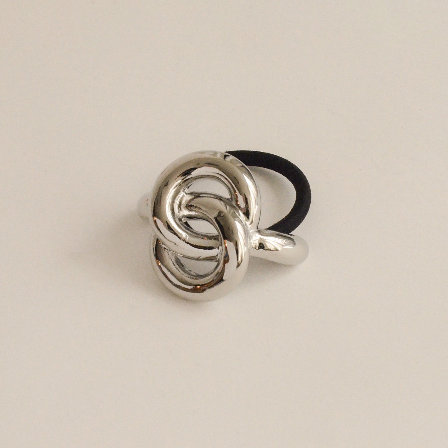A silver hair cuff tie with an eternal loop