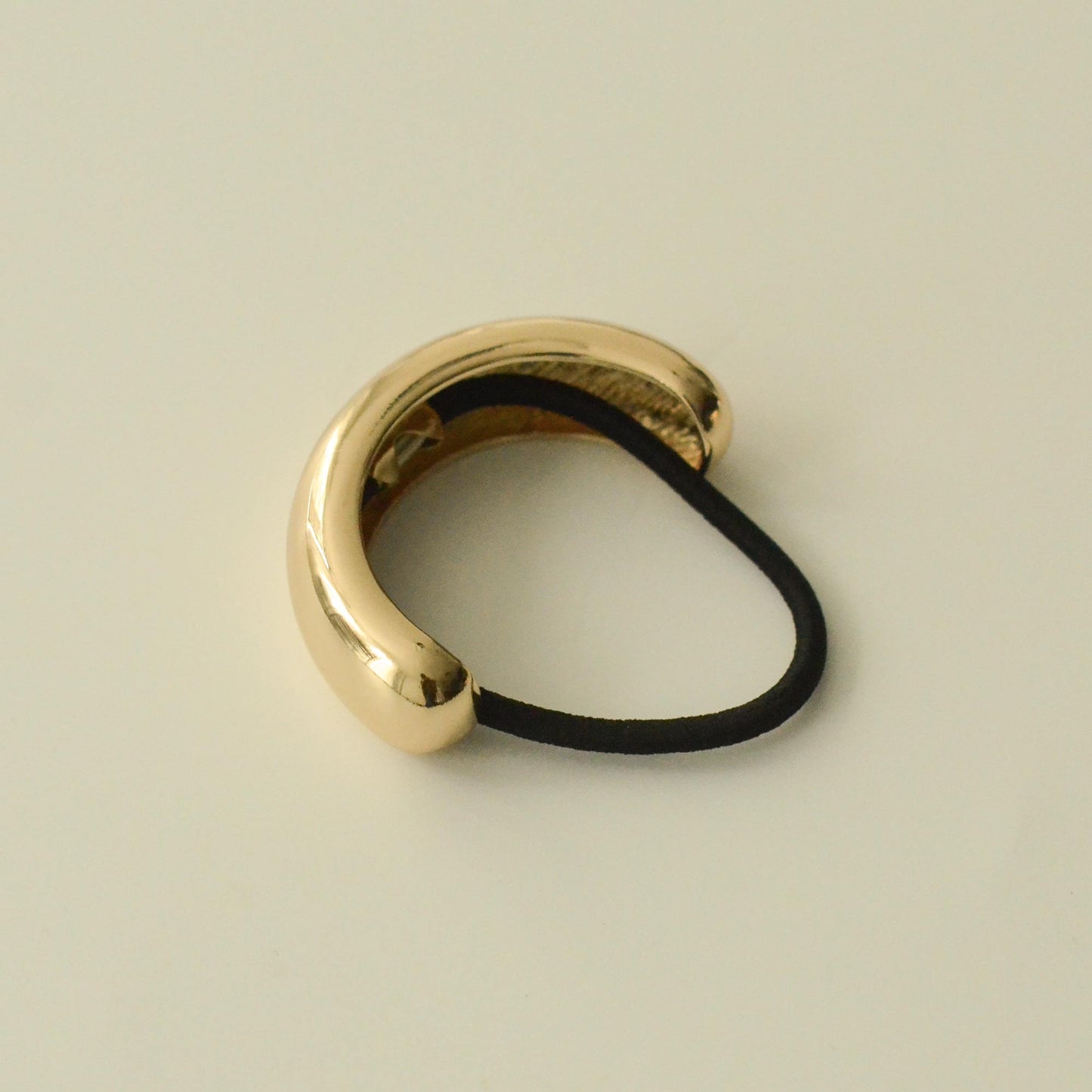 a hair tie with gold metal cuff