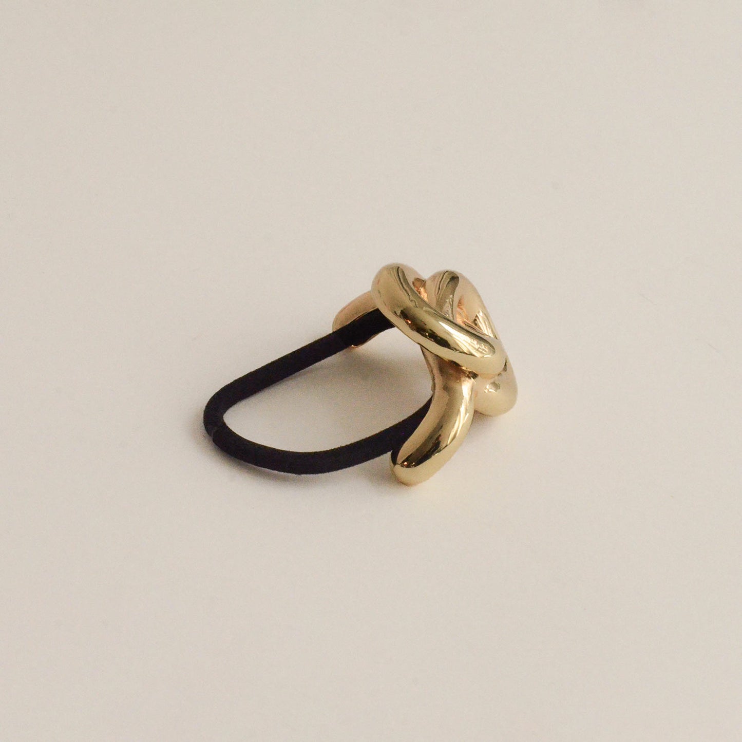 A gold hair cuff tie with an eternal loop design