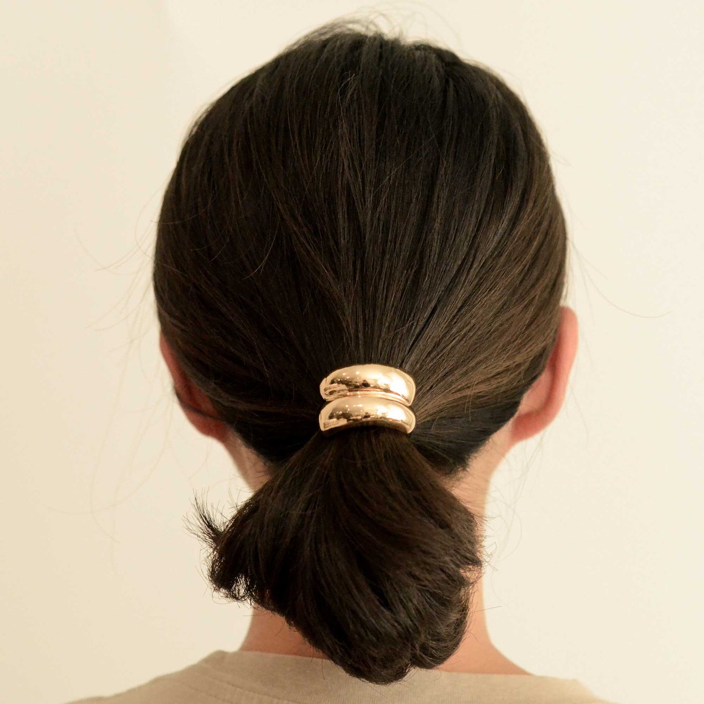 a lady with mini double gold hair cuff tie