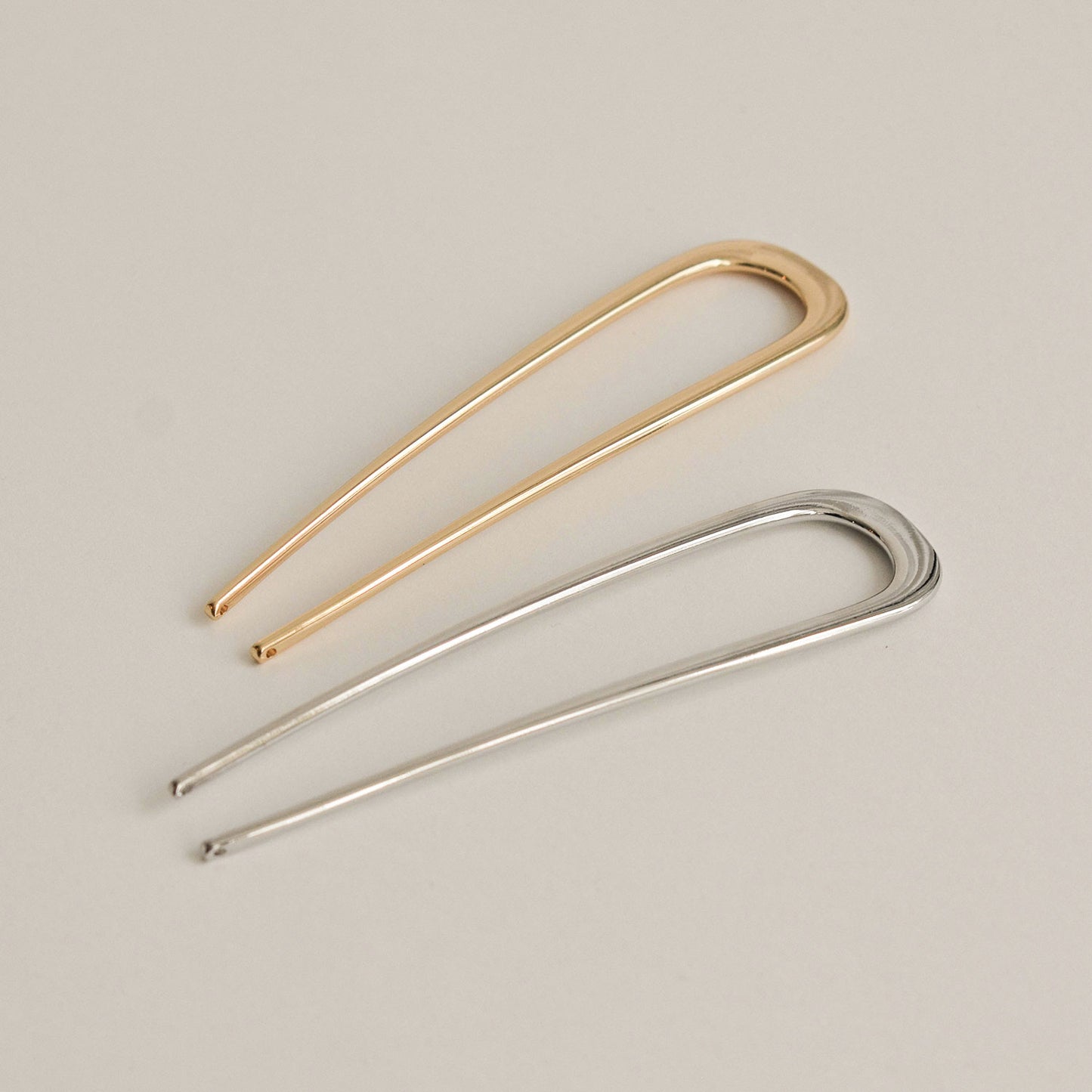two colors of u-shaped hair sticks: gold and silver