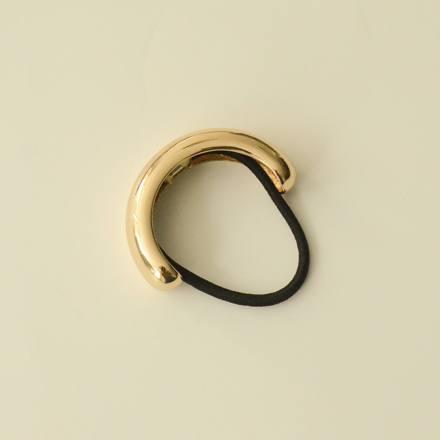 top view of gold wide cuff hair tie