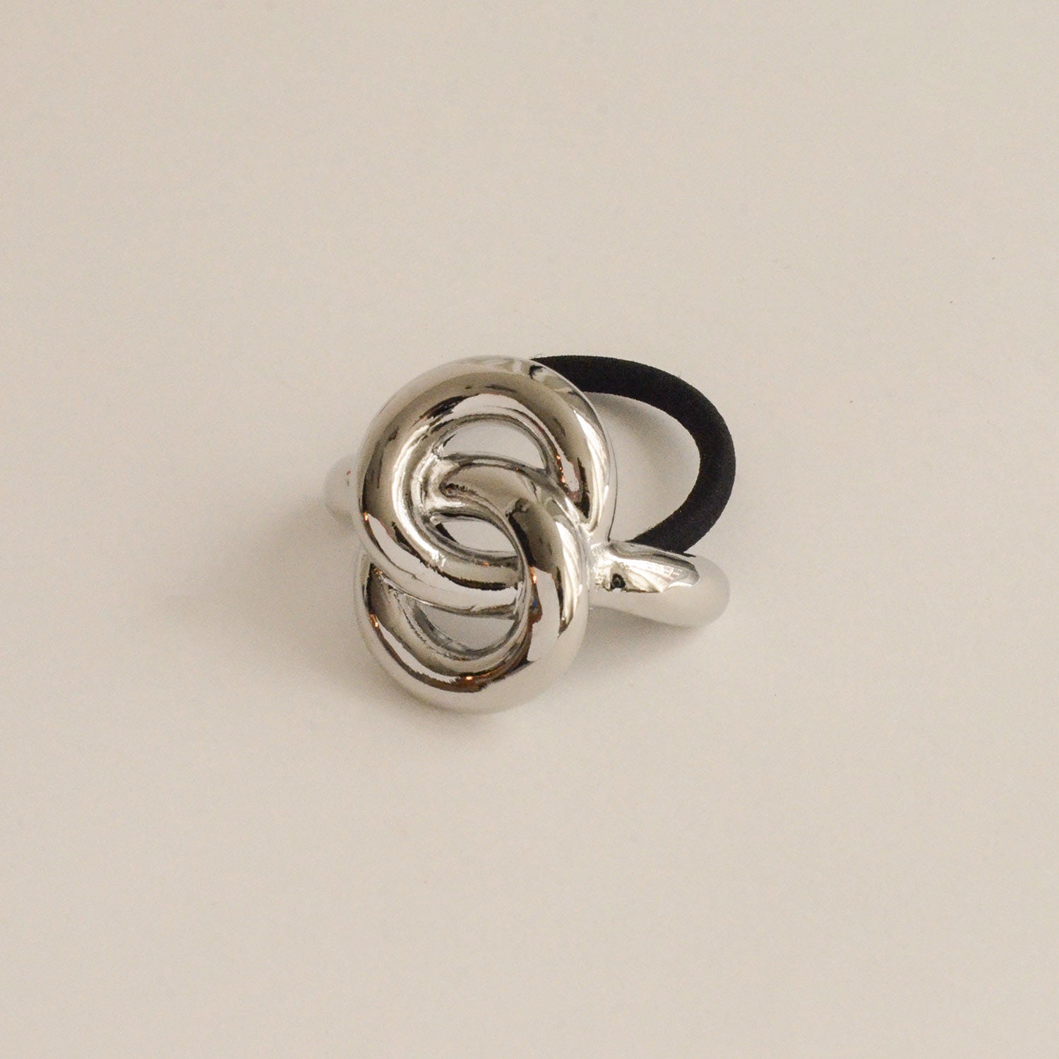 A silver hair cuff tie with an eternal loop