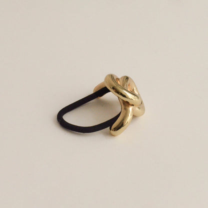 A gold hair cuff tie with an eternal loop design