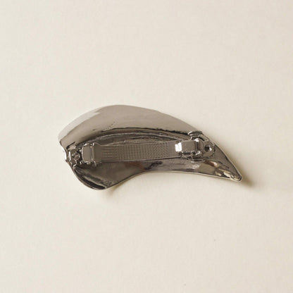 back side of silver barrette hair clip with a shape of leaf