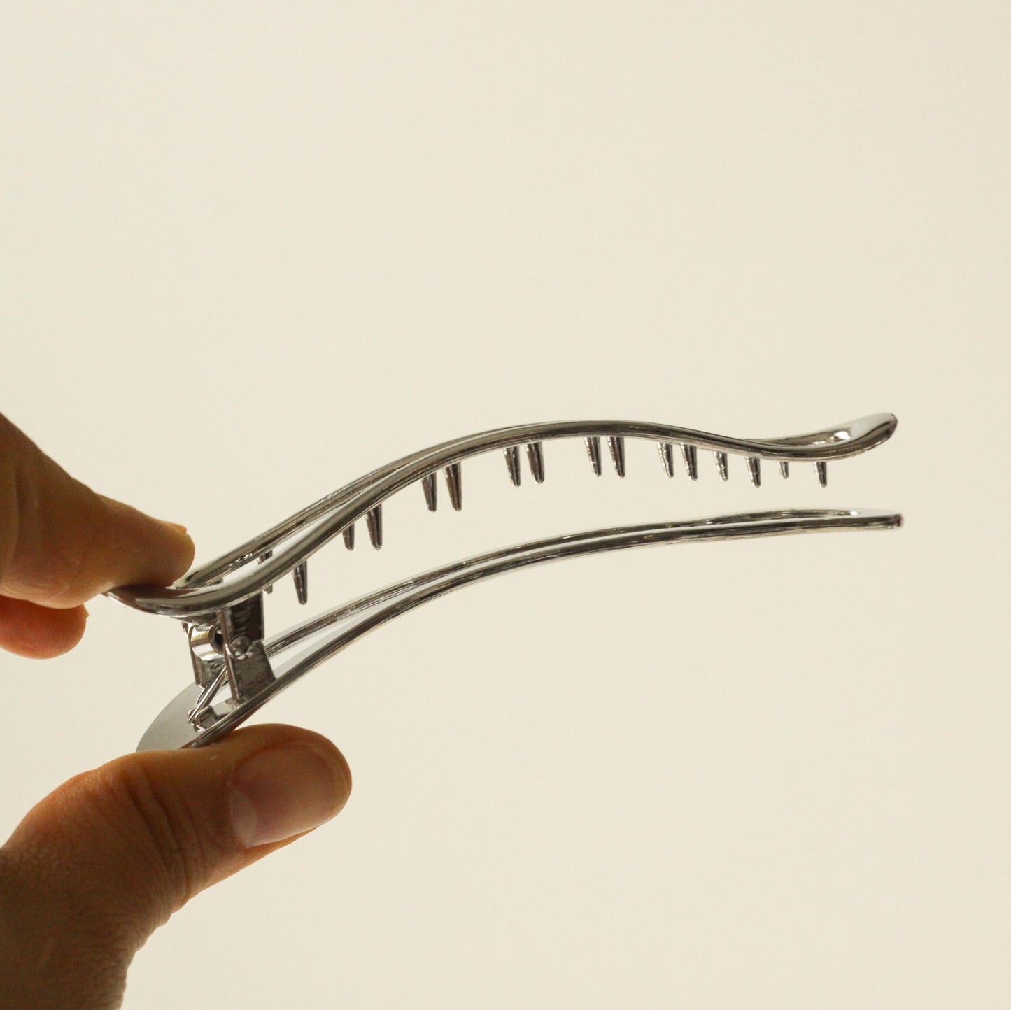 holding long silver hair claw clip