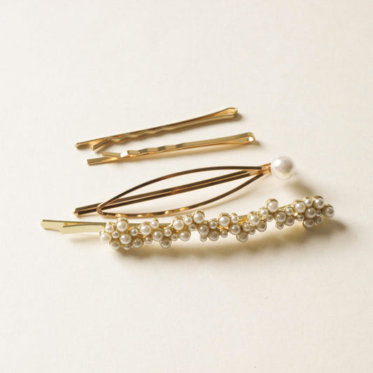 2 pieces of polished metal bobby pins and 2 pieces of pearl studded bobby pins