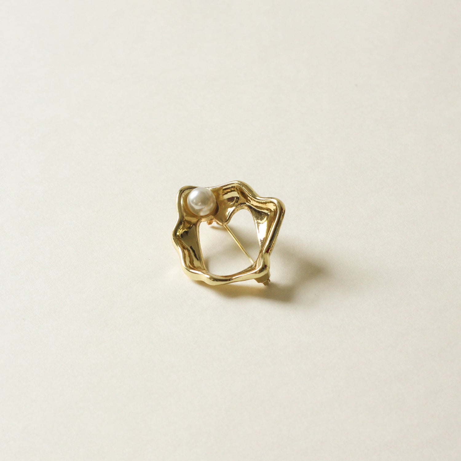 organic shaped metal brooch with pearl stud