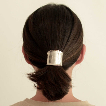 a lady wearing a silver metal hair cuff holder